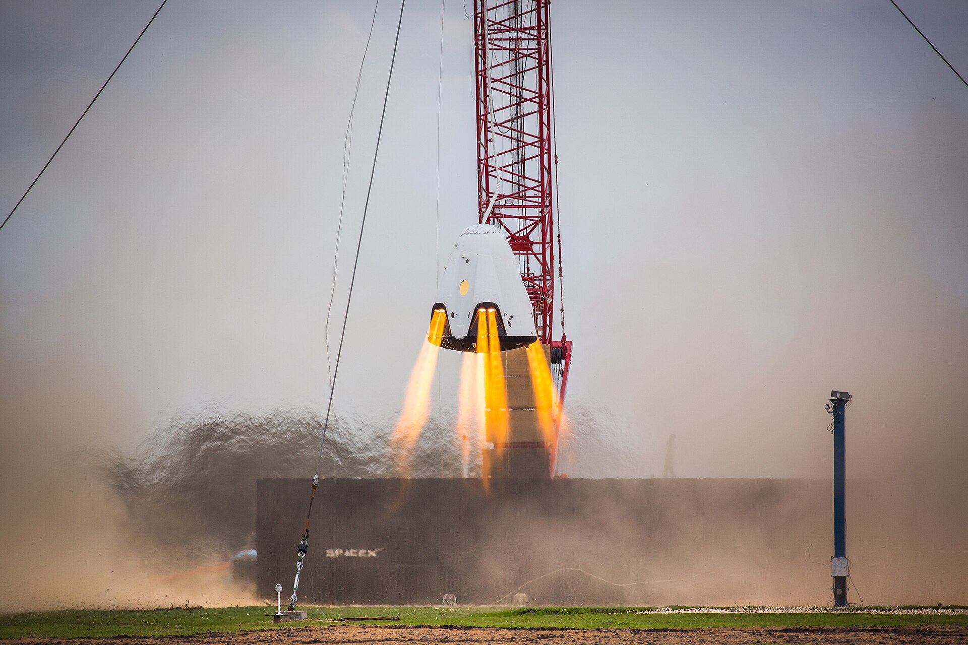 A full-size test article of the SpaceX Crew Dragon named DragonFly fires its eight SuperDraco engines in a development test of its ability to land with the accuracy of a helicopter