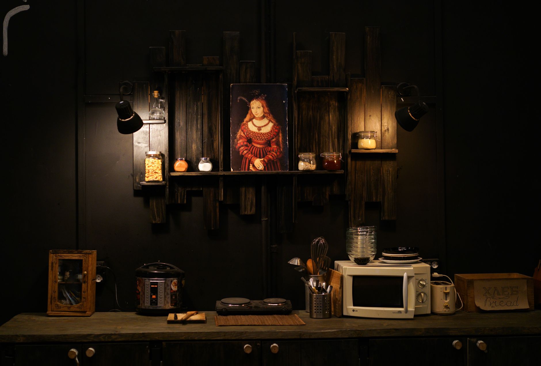 Dark-themed kitchen setup with vintage decor and kitchenware.